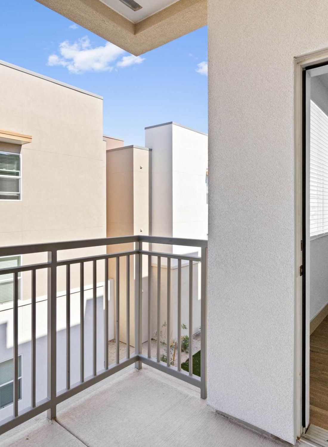 A balcony with a door open.